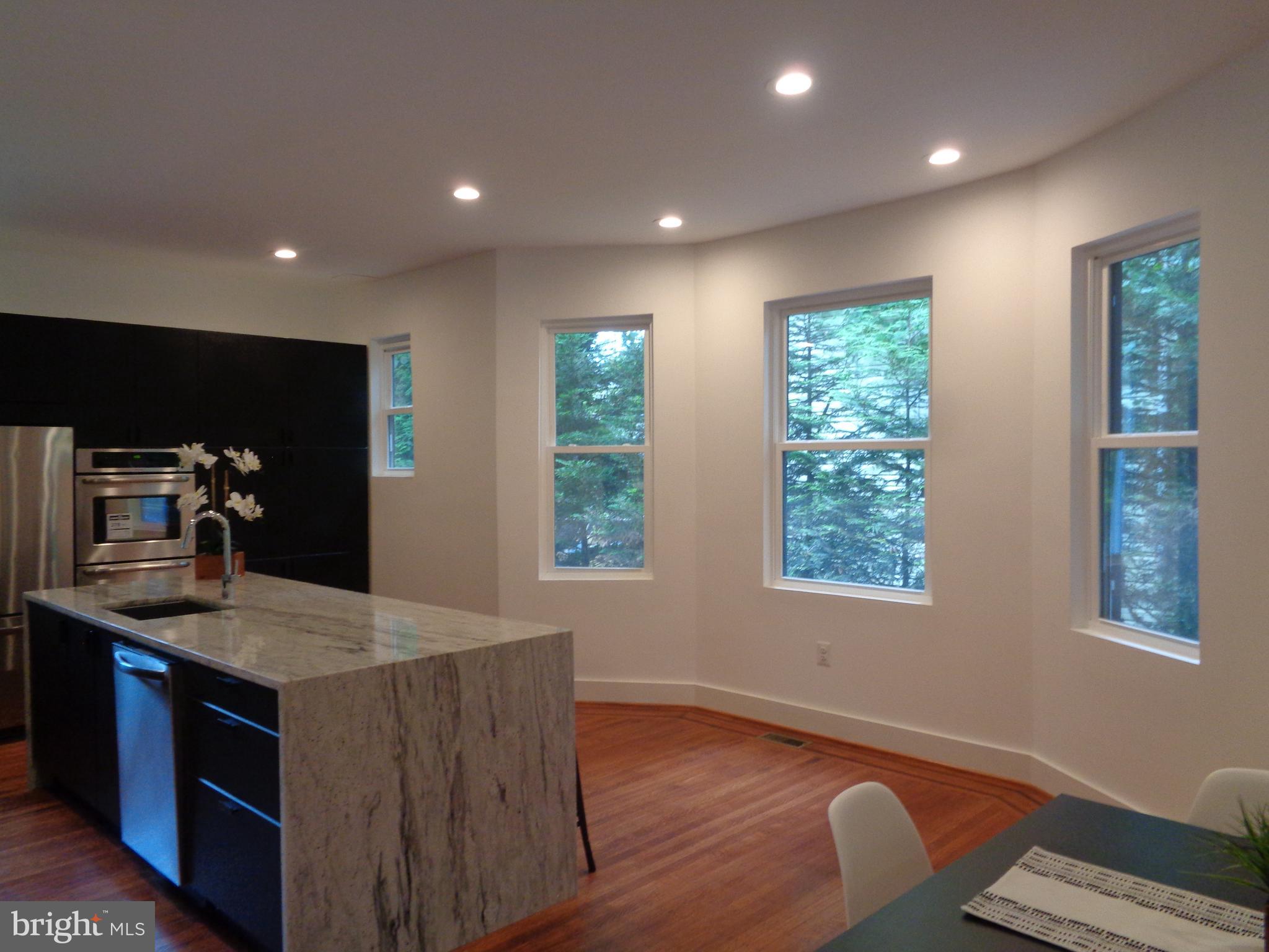 5105 Roland Avenue Baltimore, MD 21210 - Photo 4 of 19 a kitchen with a sink stove and wooden floor