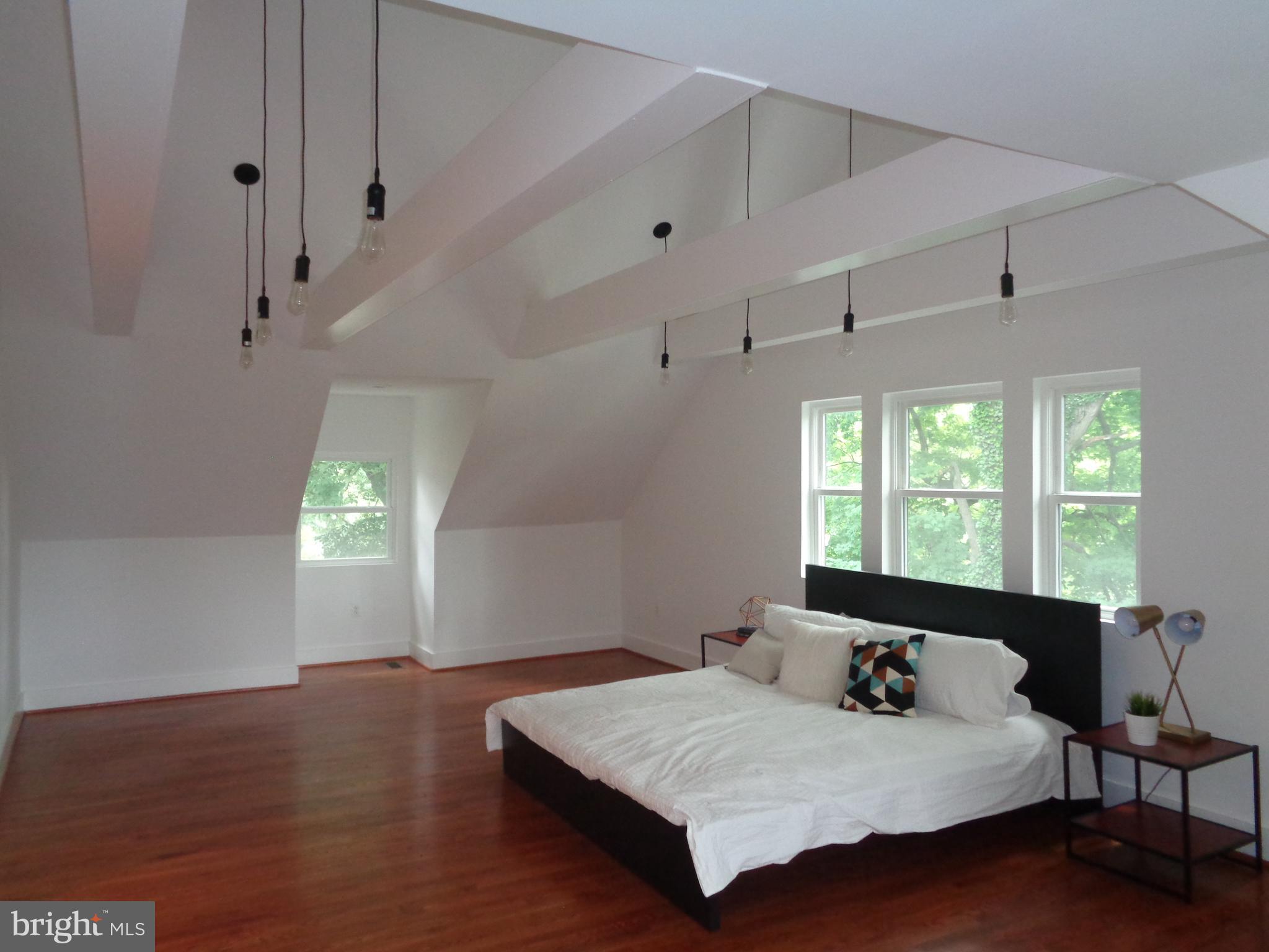 5105 Roland Avenue Baltimore, MD 21210 - Photo 8 of 19 a bedroom with a bed and window