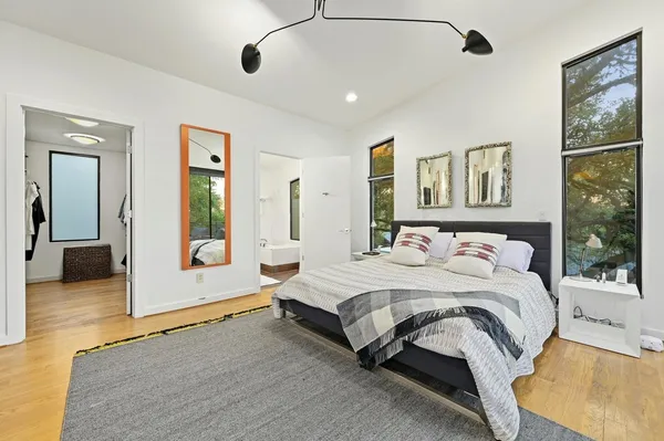 a spacious bedroom with a bed and a large window