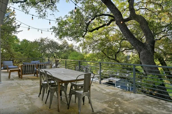 a view of a dinning table and chairs in the roof deck
