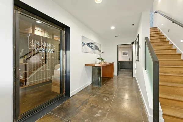 a view of a hallway with wooden floor and staircase
