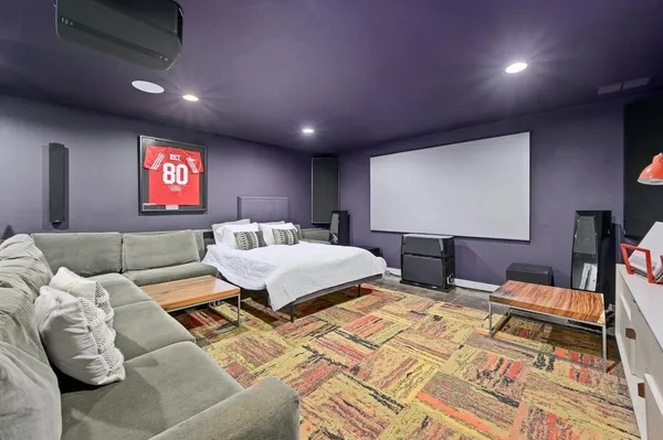 a spacious bedroom with a bed and glass tables