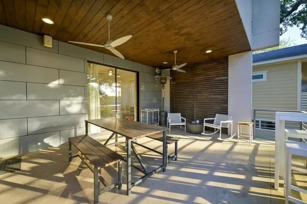 a building outdoor space with patio furniture and potted plants