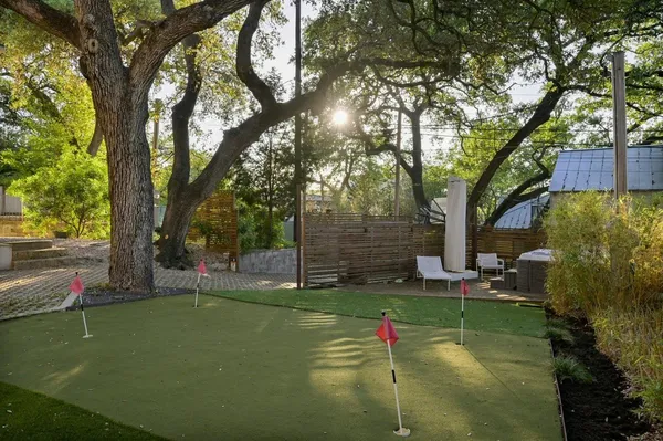 a backyard of a house with table and chairs