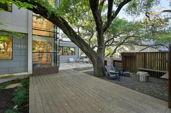 a view of backyard with a table and chairs and wooden fence