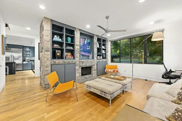 a living room with furniture fireplace and flat screen tv