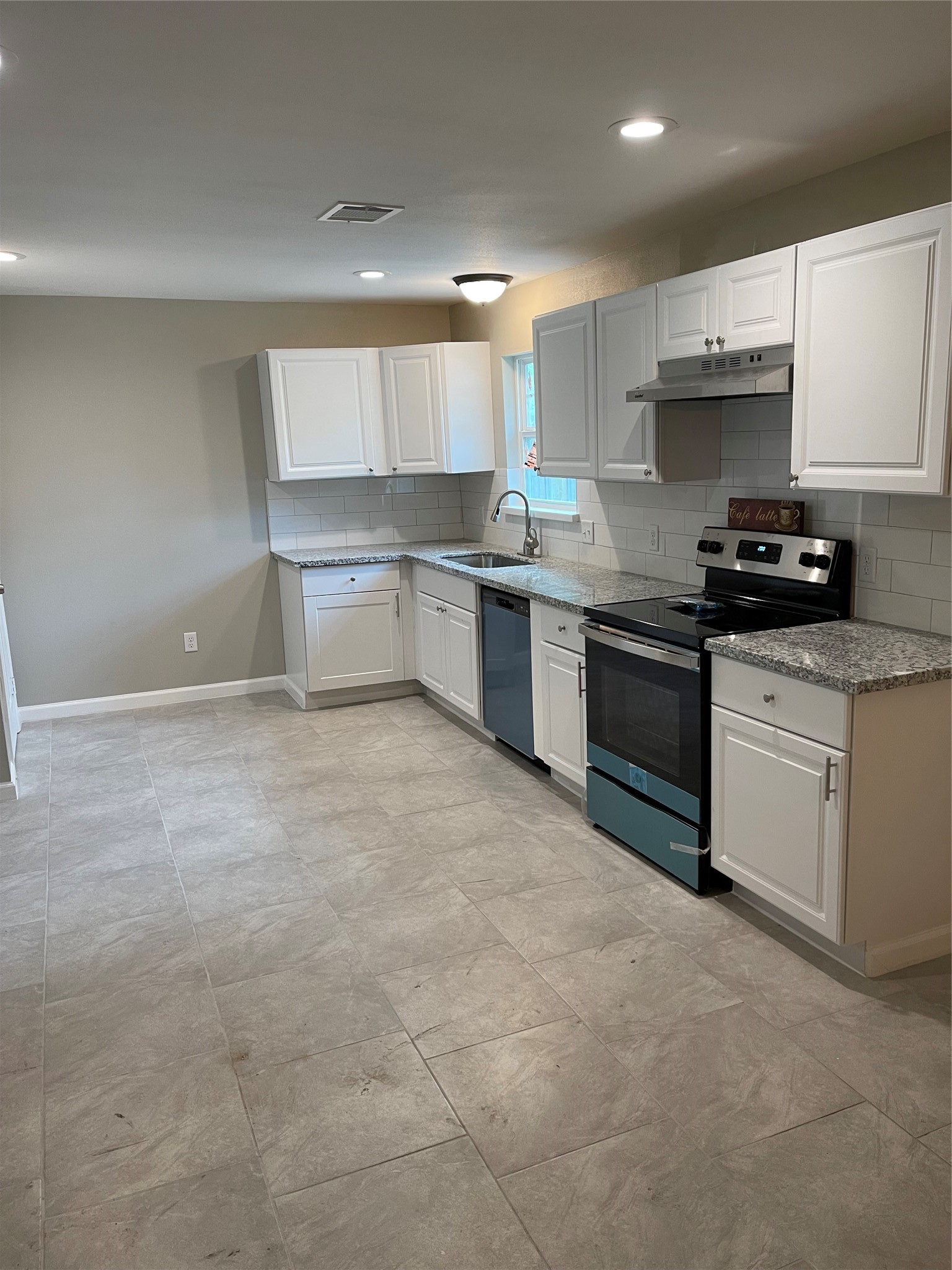 2734 Ash Road Pearland, TX 77584 - Photo 4 of 15 a kitchen with stainless steel appliances granite countertop a stove a sink and a refrigerator