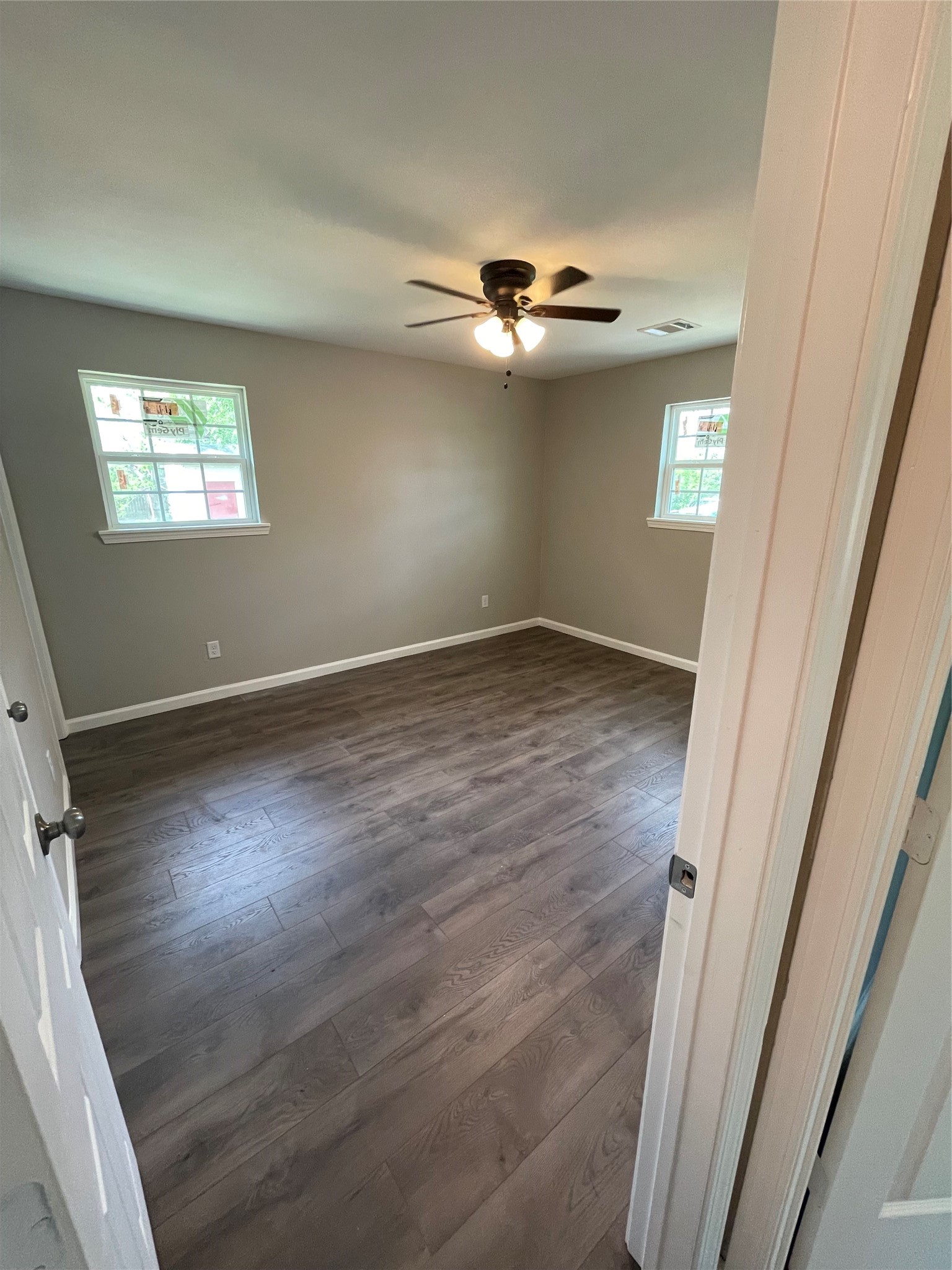 2734 Ash Road Pearland, TX 77584 - Photo 8 of 15 an empty room with wooden floor staircase and windows