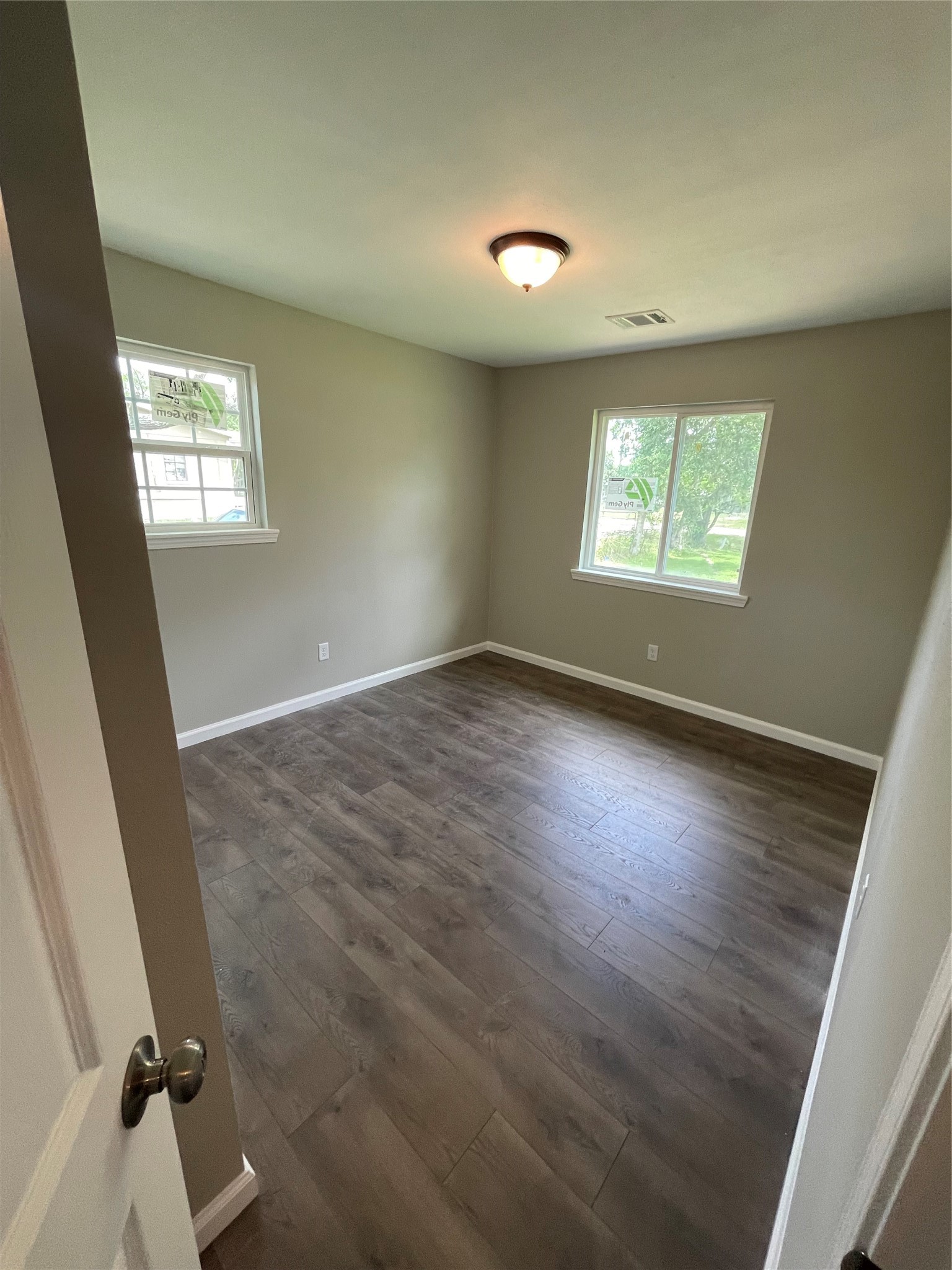 2734 Ash Road Pearland, TX 77584 - Photo 10 of 15 an empty room with wooden floor and windows