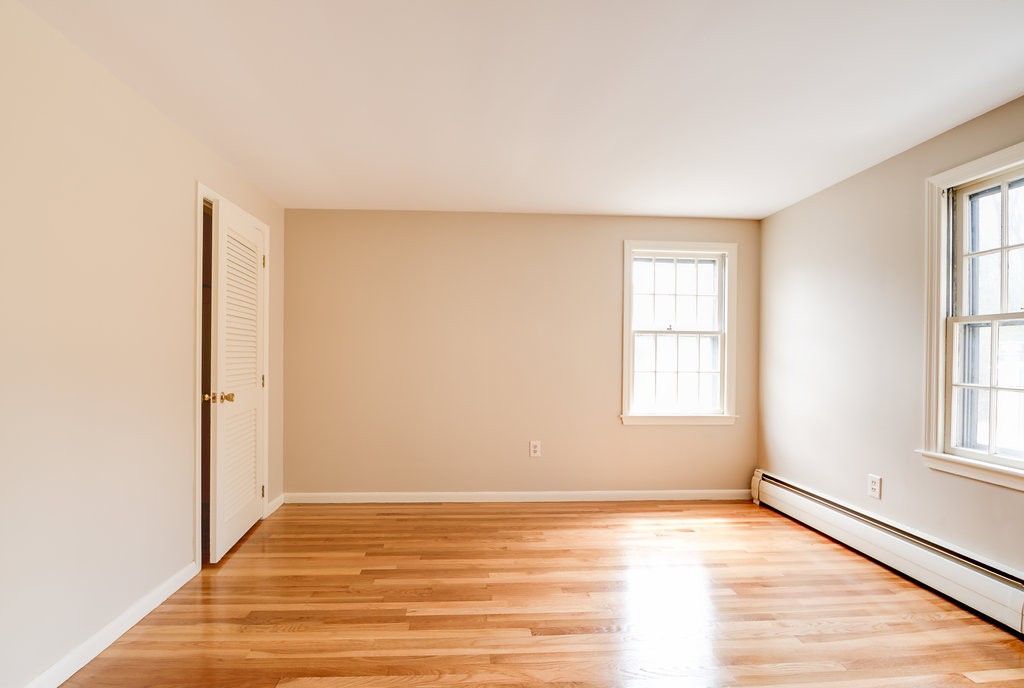 60 Woodcrest Road Boxford, MA 01921 - Photo 13 of 23 an empty room with wooden floor and windows