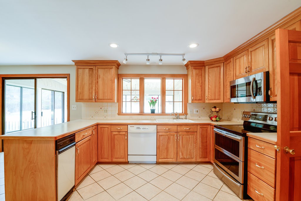 60 Woodcrest Road Boxford, MA 01921 - Photo 2 of 23 a kitchen with stainless steel appliances granite countertop a stove a sink and a microwave