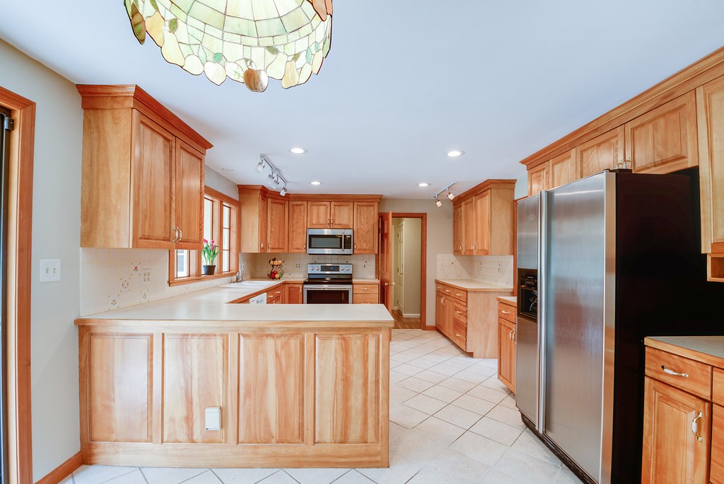 60 Woodcrest Road Boxford, MA 01921 - Photo 3 of 23 a kitchen with stainless steel appliances granite countertop a refrigerator a stove and a sink