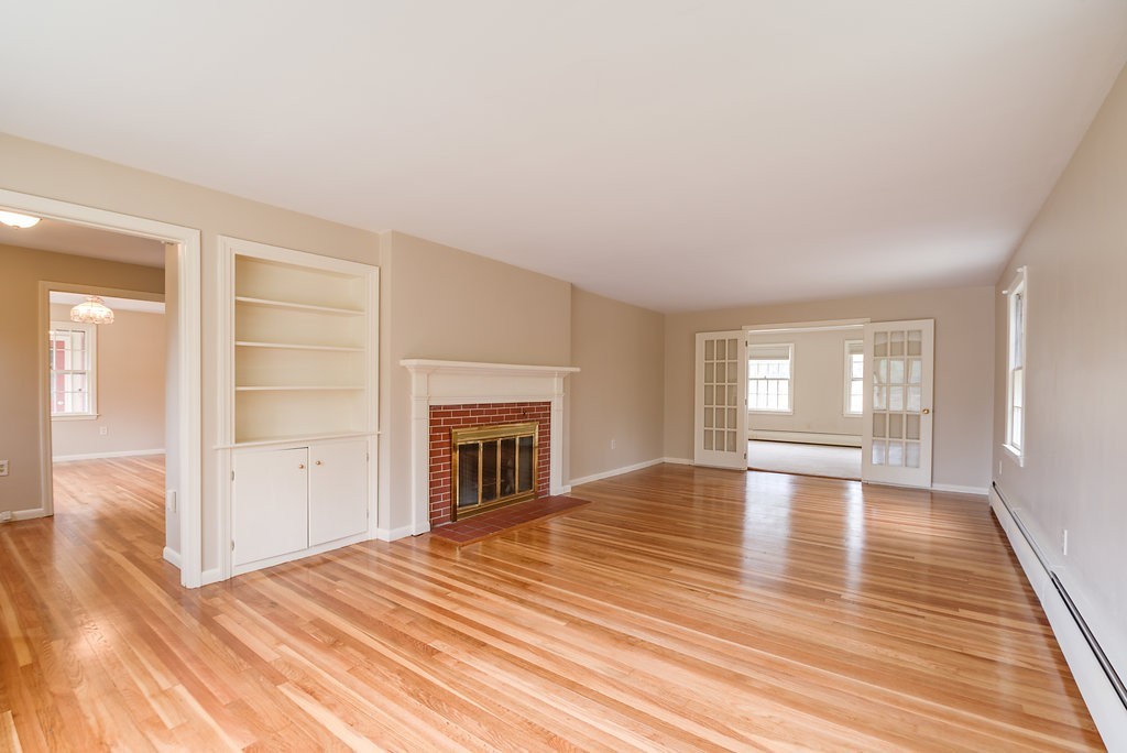 60 Woodcrest Road Boxford, MA 01921 - Photo 4 of 23 wooden floor fireplace and natural light in room