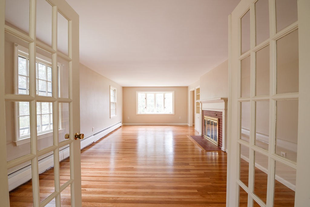 60 Woodcrest Road Boxford, MA 01921 - Photo 5 of 23 a view of an empty room with wooden floor and a window