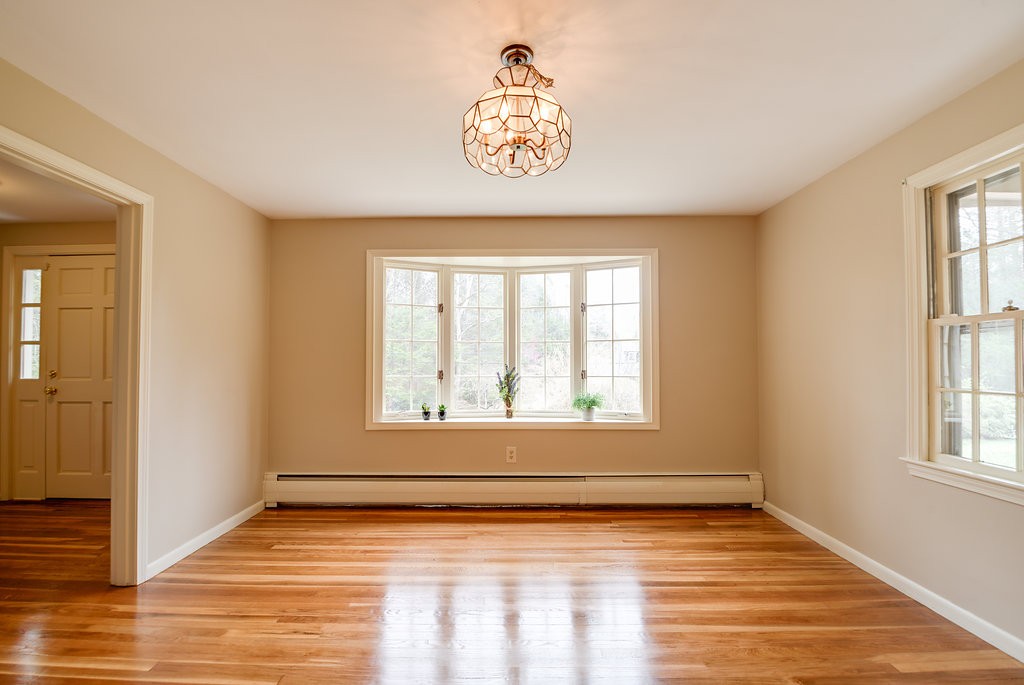 60 Woodcrest Road Boxford, MA 01921 - Photo 6 of 23 a view of an empty room with wooden floor and a window