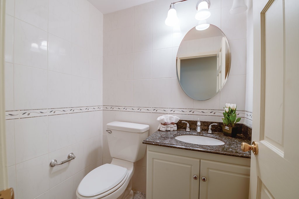 60 Woodcrest Road Boxford, MA 01921 - Photo 8 of 23 a bathroom with a granite countertop toilet sink and mirror