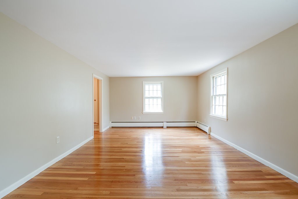 60 Woodcrest Road Boxford, MA 01921 - Photo 9 of 23 a view of an empty room with wooden floor and window
