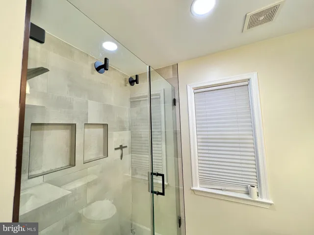 a bathroom with a shower and a mirror