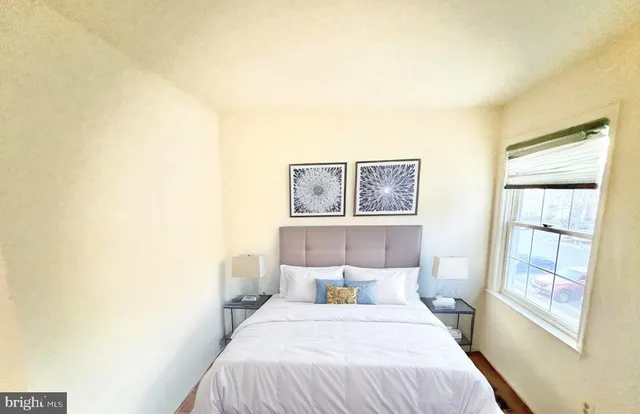 a bedroom with a bed and a window