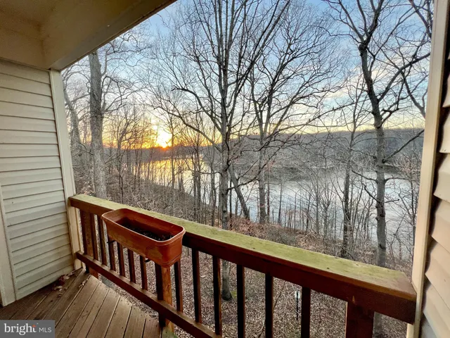 a view of balcony with wooden floor and fence