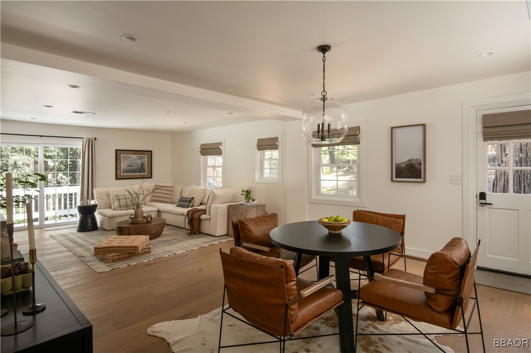 920 Oak Road Lake Arrowhead, CA 92385 - Photo 2 of 28 a living room with dining table and a wooden floor