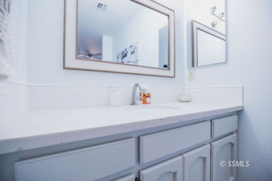 199 East Upjohn Avenue Ridgecrest, CA 93555 - Photo 24 of 30 a bathroom with a sink and a mirror
