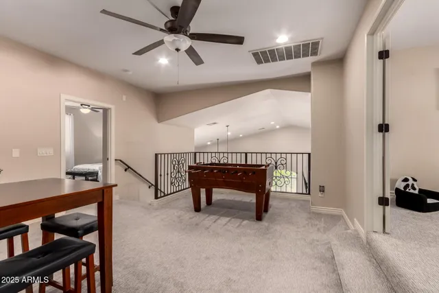 a view of a swimming pool with a lawn chairs under an umbrella