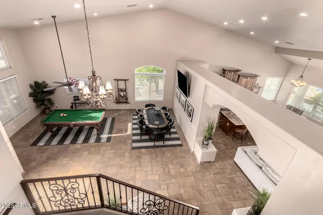a view of a patio with couches potted plants and a big yard