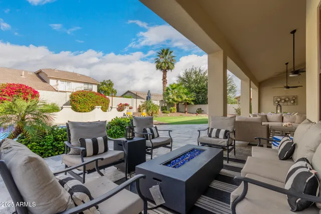 a view of a house with swimming pool and sitting area