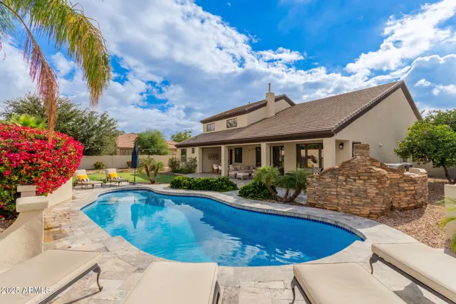 a view of a backyard with plants and a patio