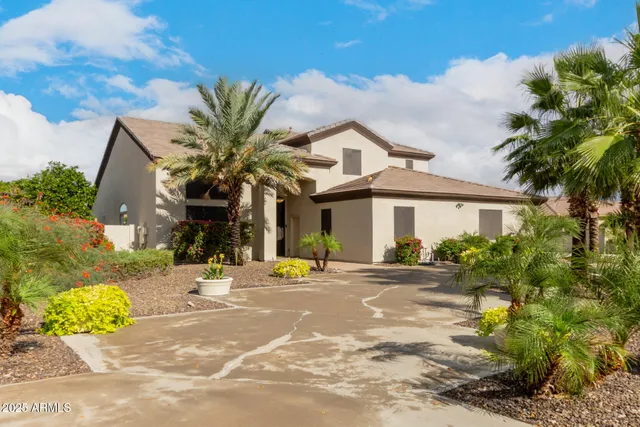 a front view of a house with a garden