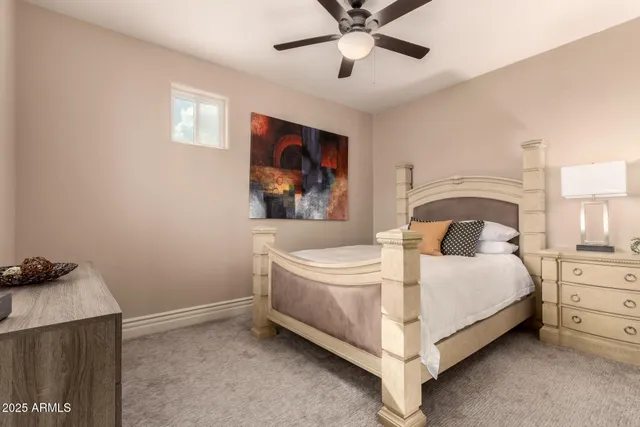 a bed sitting in a bedroom next to a window