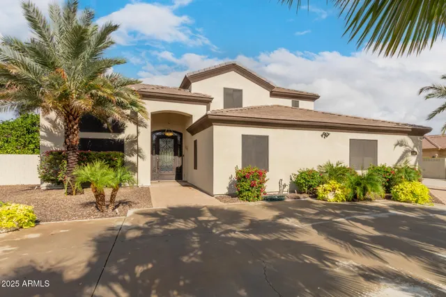a living room with furniture kitchen view and a chandelier