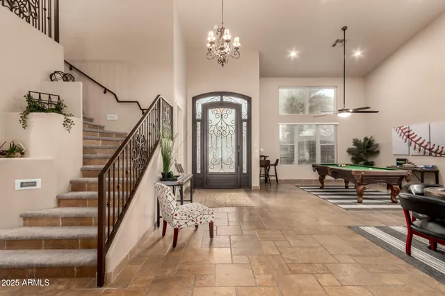 a kitchen with kitchen island a stove a center island a refrigerator and a fireplace