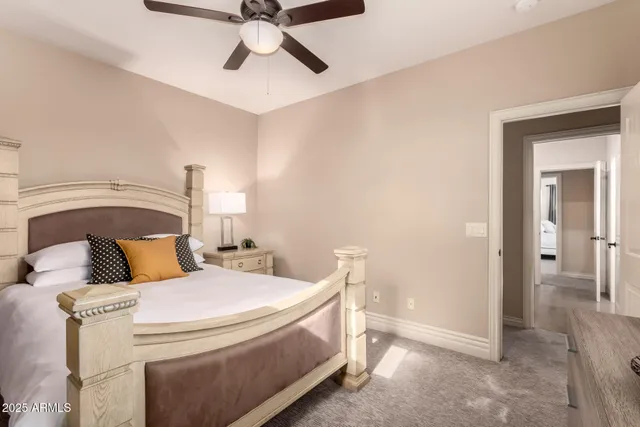 a bedroom with a bed and ceiling fan