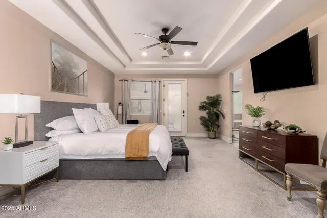 a bedroom with a large bed and a flat screen tv