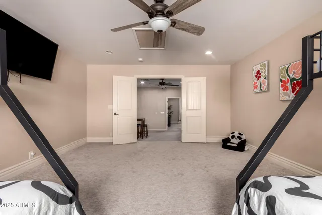 a bedroom with a bed potted plant on the dresser and a window