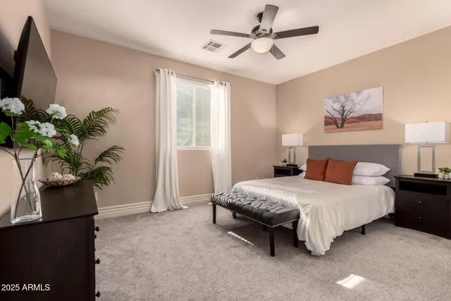 a bedroom with a bed and a chandelier