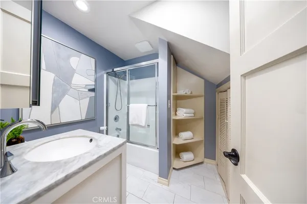 a bathroom with a granite countertop sink and mirror
