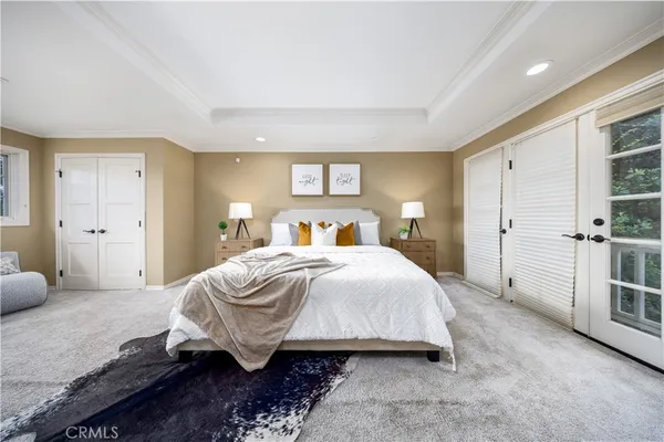 a bedroom with a large bed and a couch
