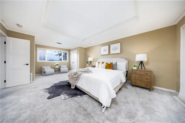 a bedroom with a bed and a couch