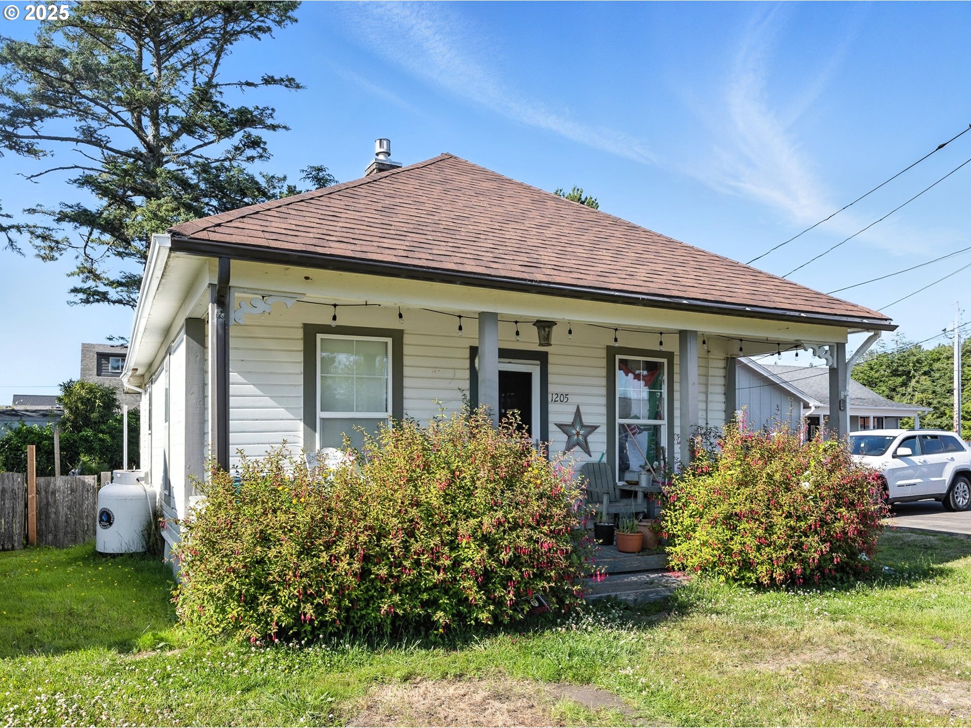 a front view of a house with a garden