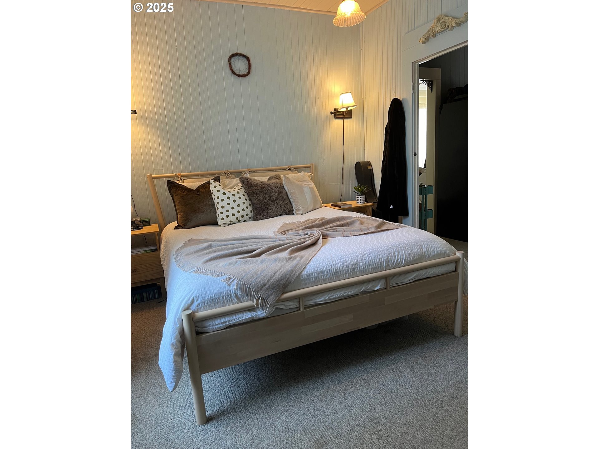 1205 49th Street Seaview, WA 98644 - Photo 18 of 36 a bedroom with a bed and a night stand