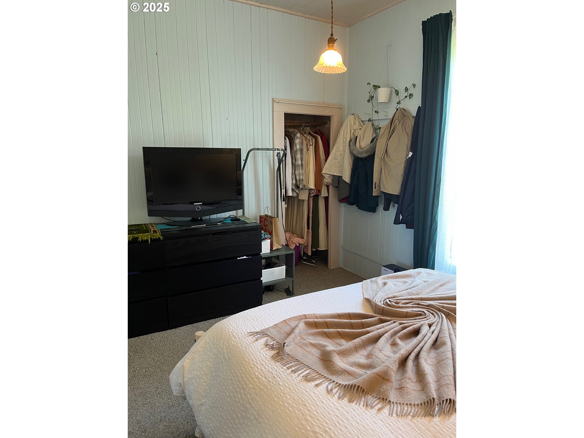 1205 49th Street Seaview, WA 98644 - Photo 19 of 36 a bedroom with a bed and a flat screen tv