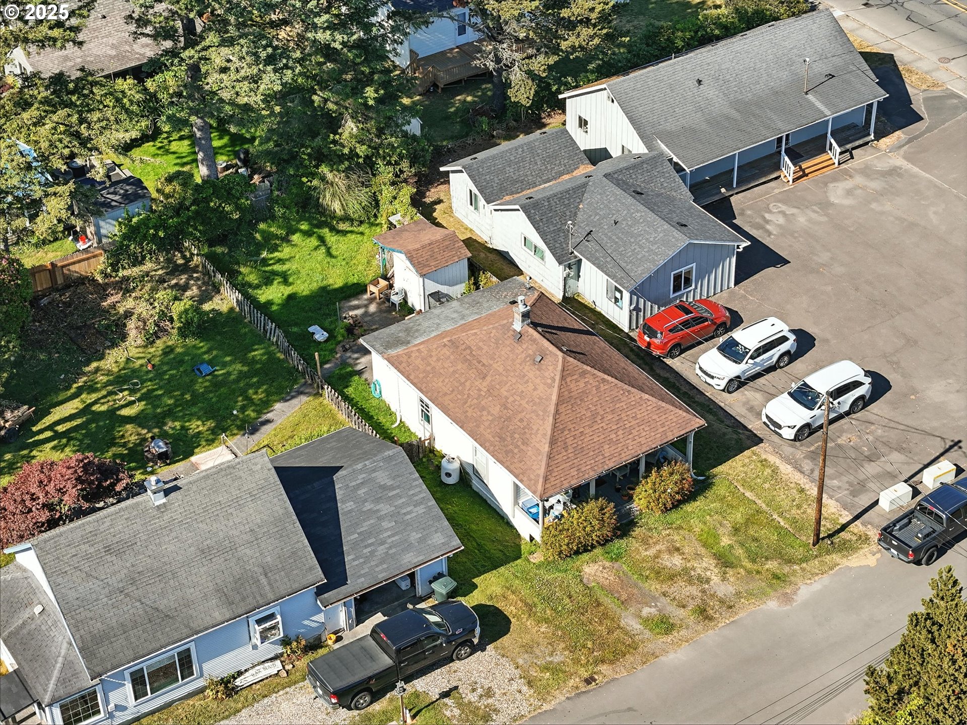 1205 49th Street Seaview, WA 98644 - Photo 2 of 36 an aerial view of a house with a yard and lake view