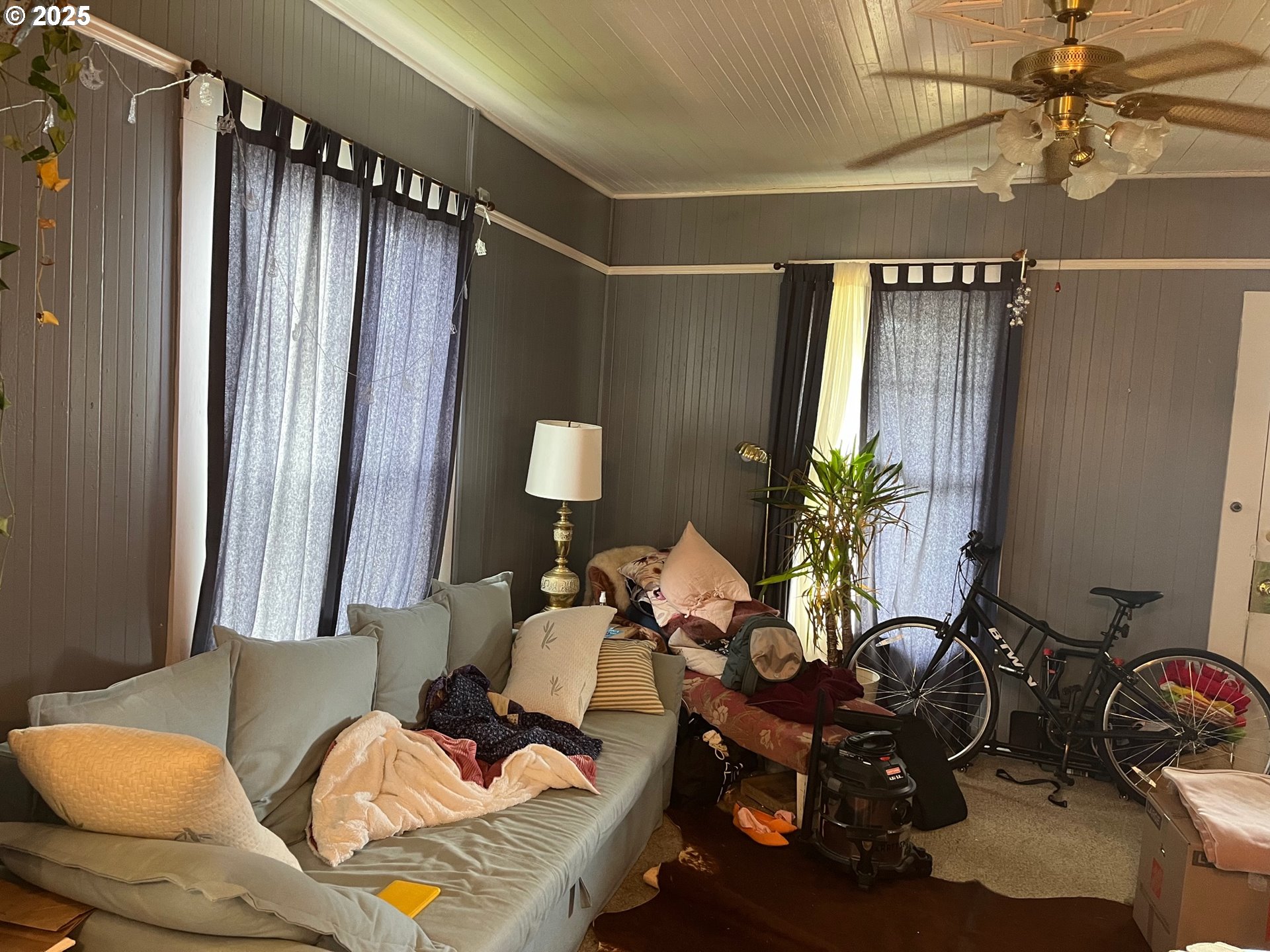 1205 49th Street Seaview, WA 98644 - Photo 21 of 36 a living room with furniture a chandelier and a window