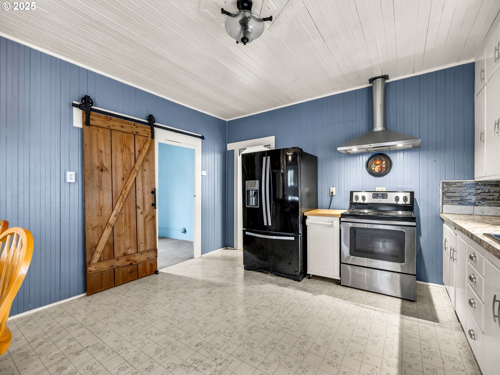 1205 49th Street Seaview, WA 98644 - Photo 25 of 36 a kitchen with stainless steel appliances granite countertop a stove and a refrigerator