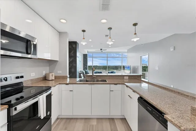 a kitchen with a sink stove top oven and cabinets
