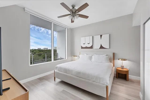 a bedroom with a bed and a large window