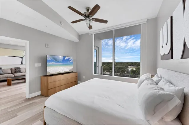 a bedroom with a large bed and a large window